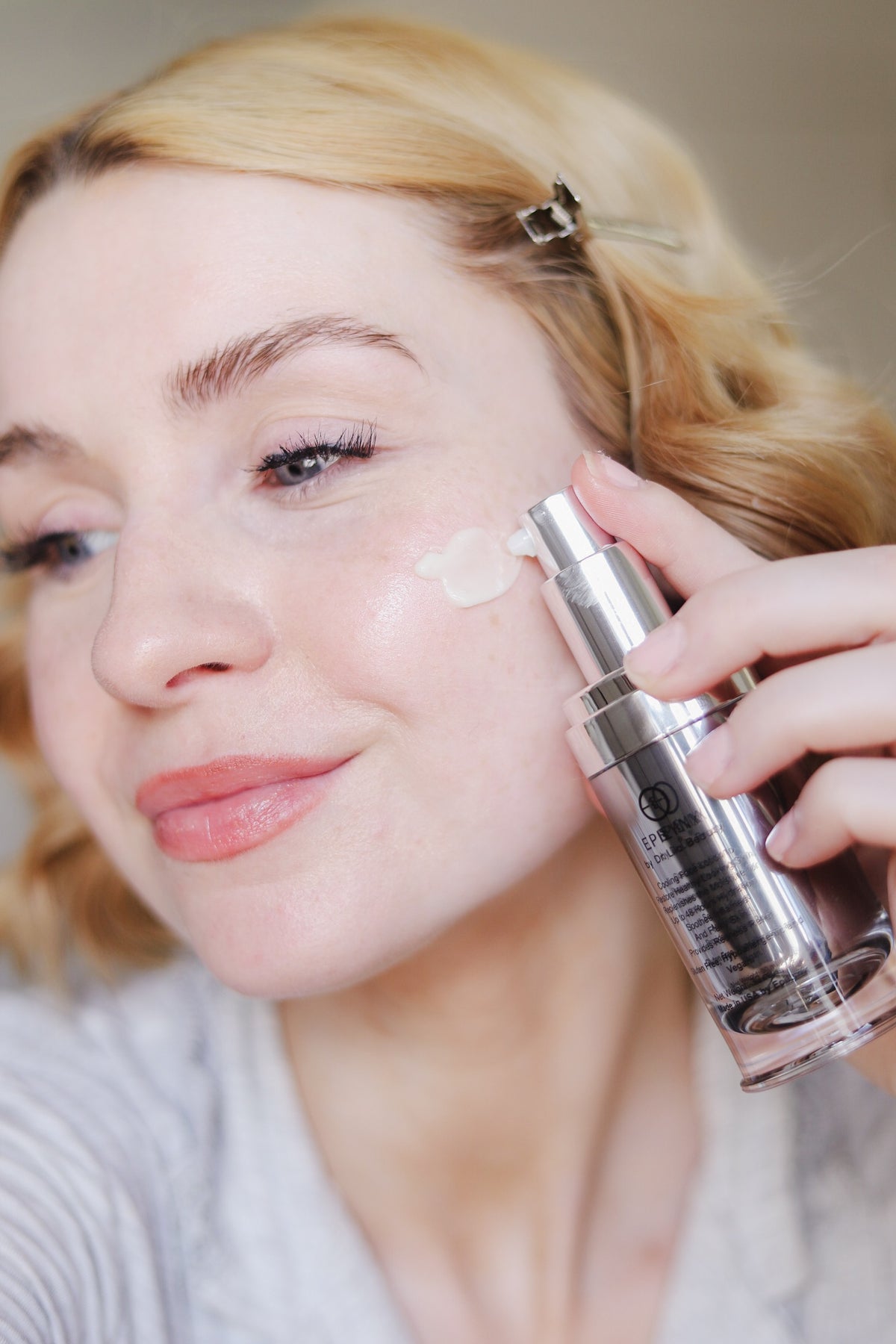 EpiLynx Episilk Crystal brightening face serum held beside the face