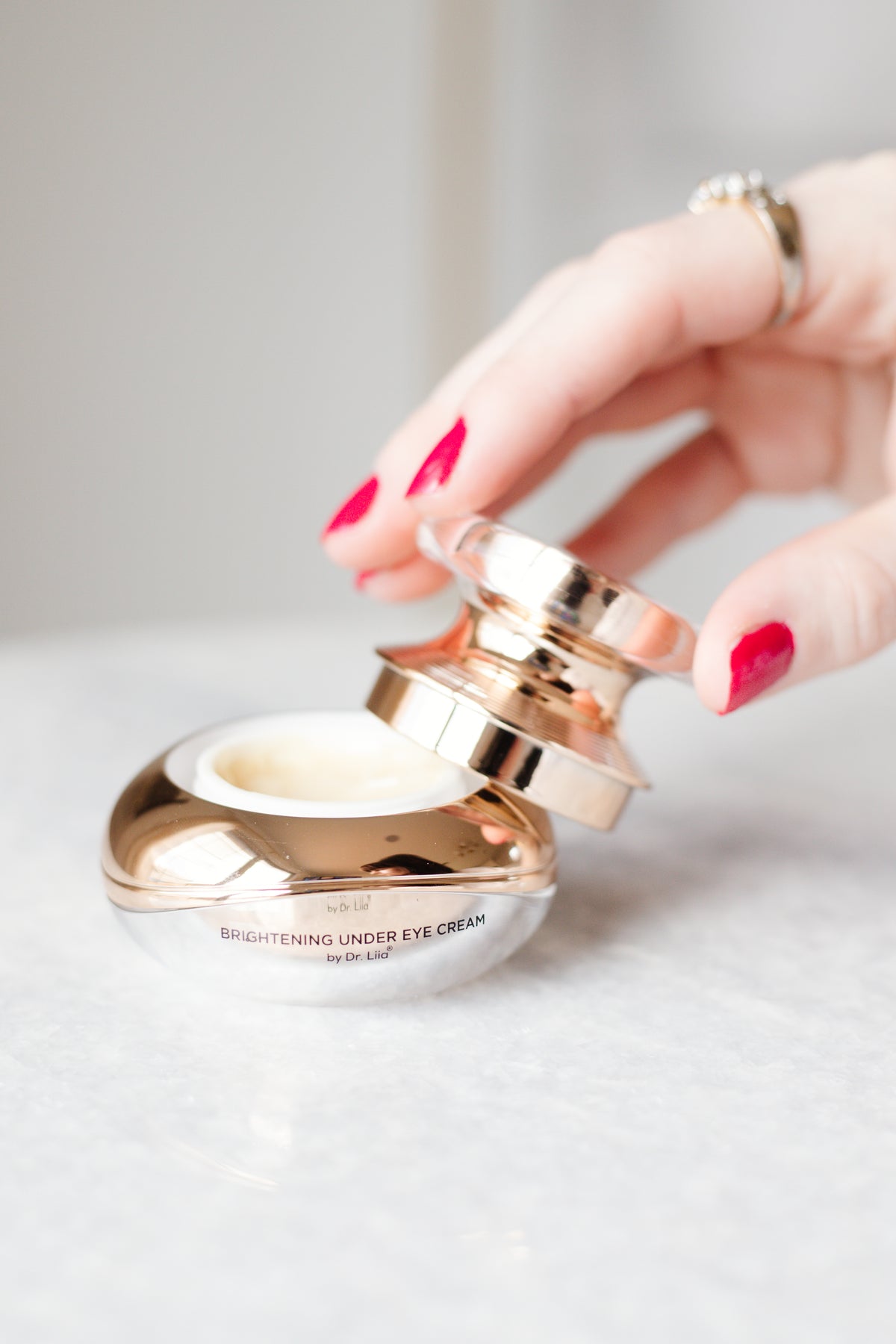 Woman applying EpiLynx peptide eye cream to reduce puffiness and dark circles
