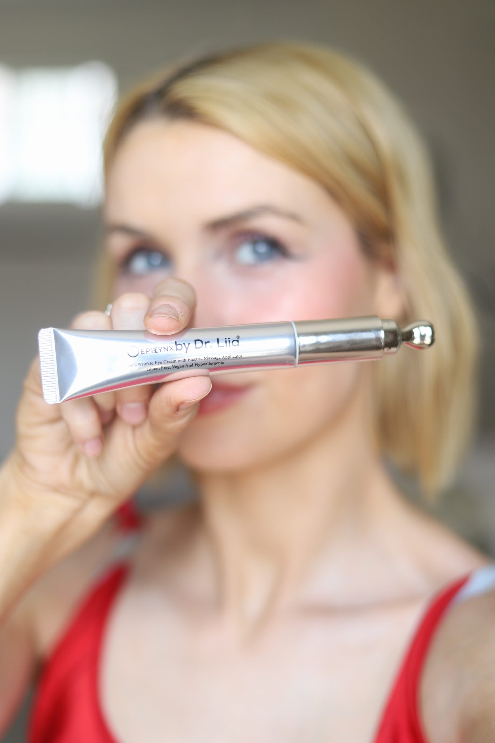 Close-up of the EpiLynx anti-wrinkle eye cream tube and its cooling metal applicator